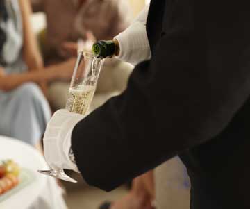 Butler-pouring-champagne Crystal Cruises
