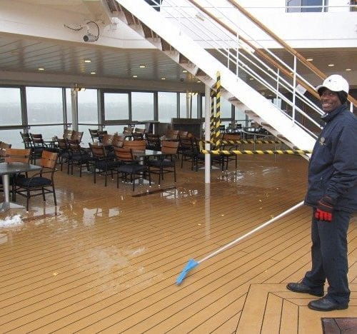 Shoveling snow on the deck on an end of the season Canada New England cruise