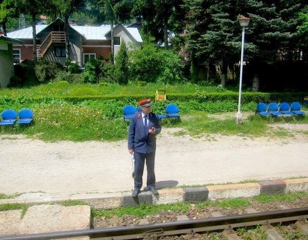 Station master gives us the go-ahead with his signal sign for our train to Bucharest