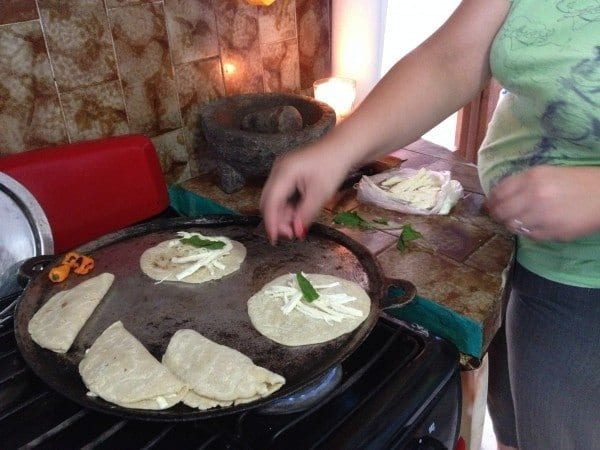 Cooking our tortillas with a cheese sauce.