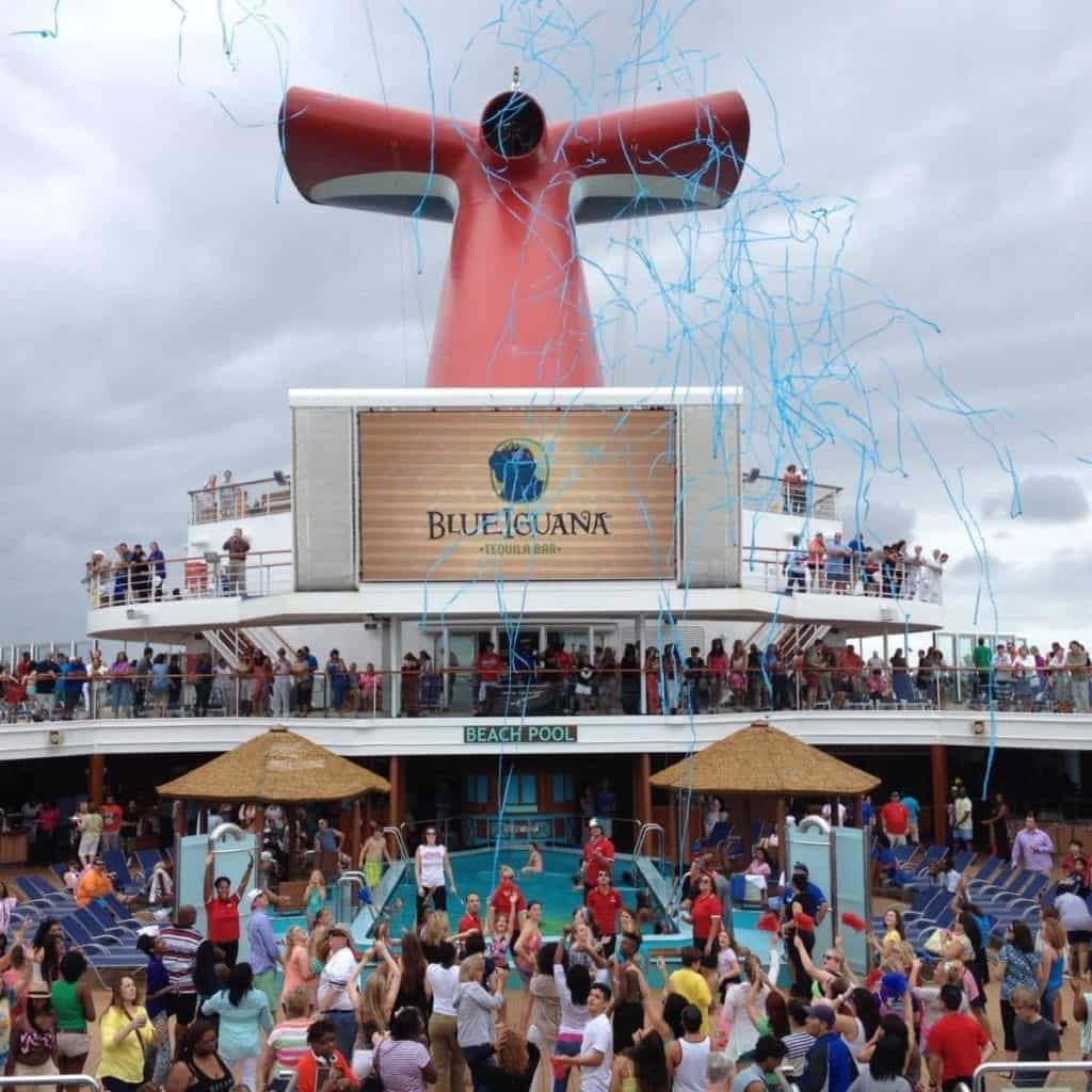 Carnival Breeze passengers partying by the pool at sailaway.
