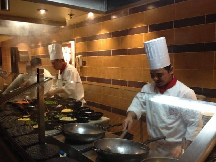 Aboard the Carnival Sunshine, the cooks at JiJi Asian Kitchen get ready for the dinner crunch time. 