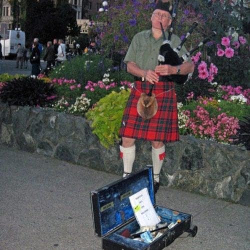 A bagpiper in the Inner Harbor fills the night air with lively tunes in Victoria, B.C.