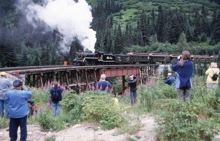The steam train crossing the trestle bridge.