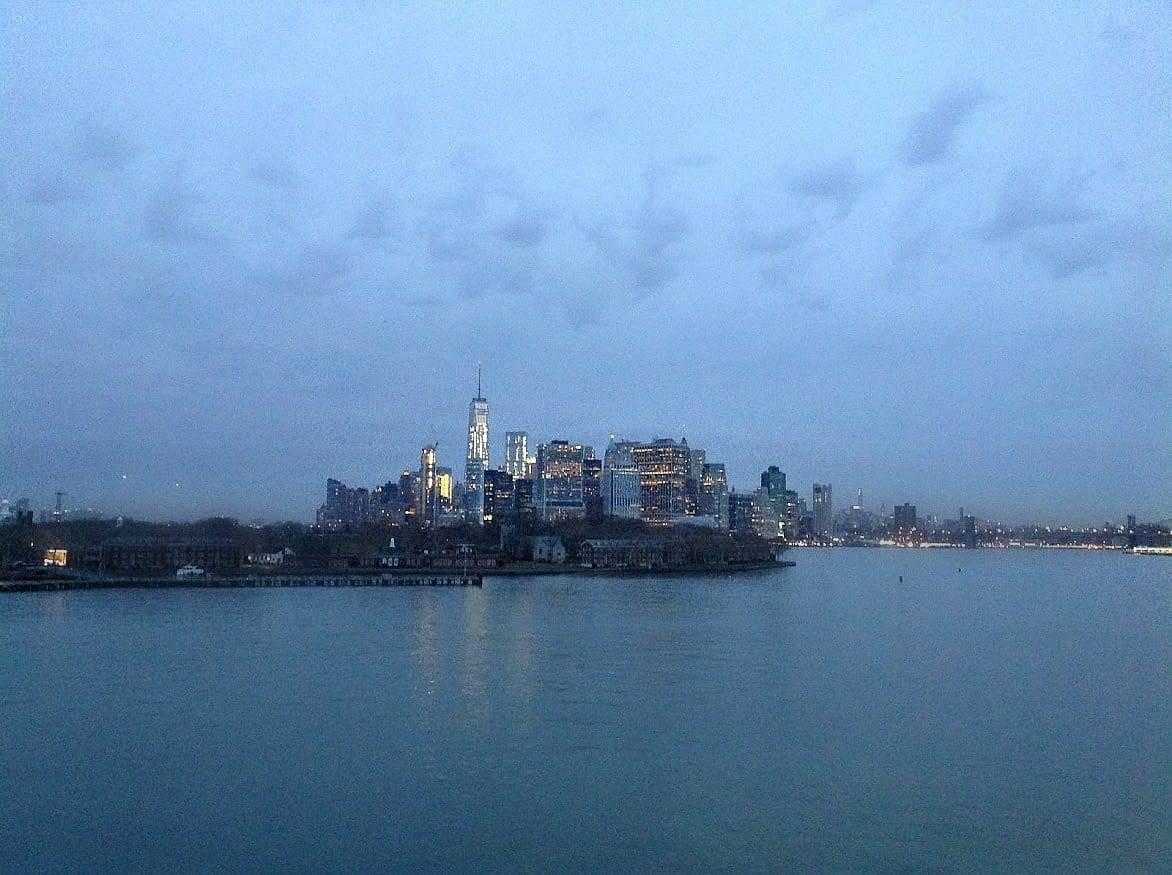 Dawn breaks over the New York City skyline as Queen Mary 2 slowly cruises up the Hudson River to Brooklyn Cruise Terminal.