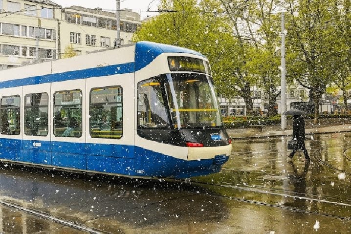 Tram in Zurich with snowflakes on a spring day before a Rhine river cruise.