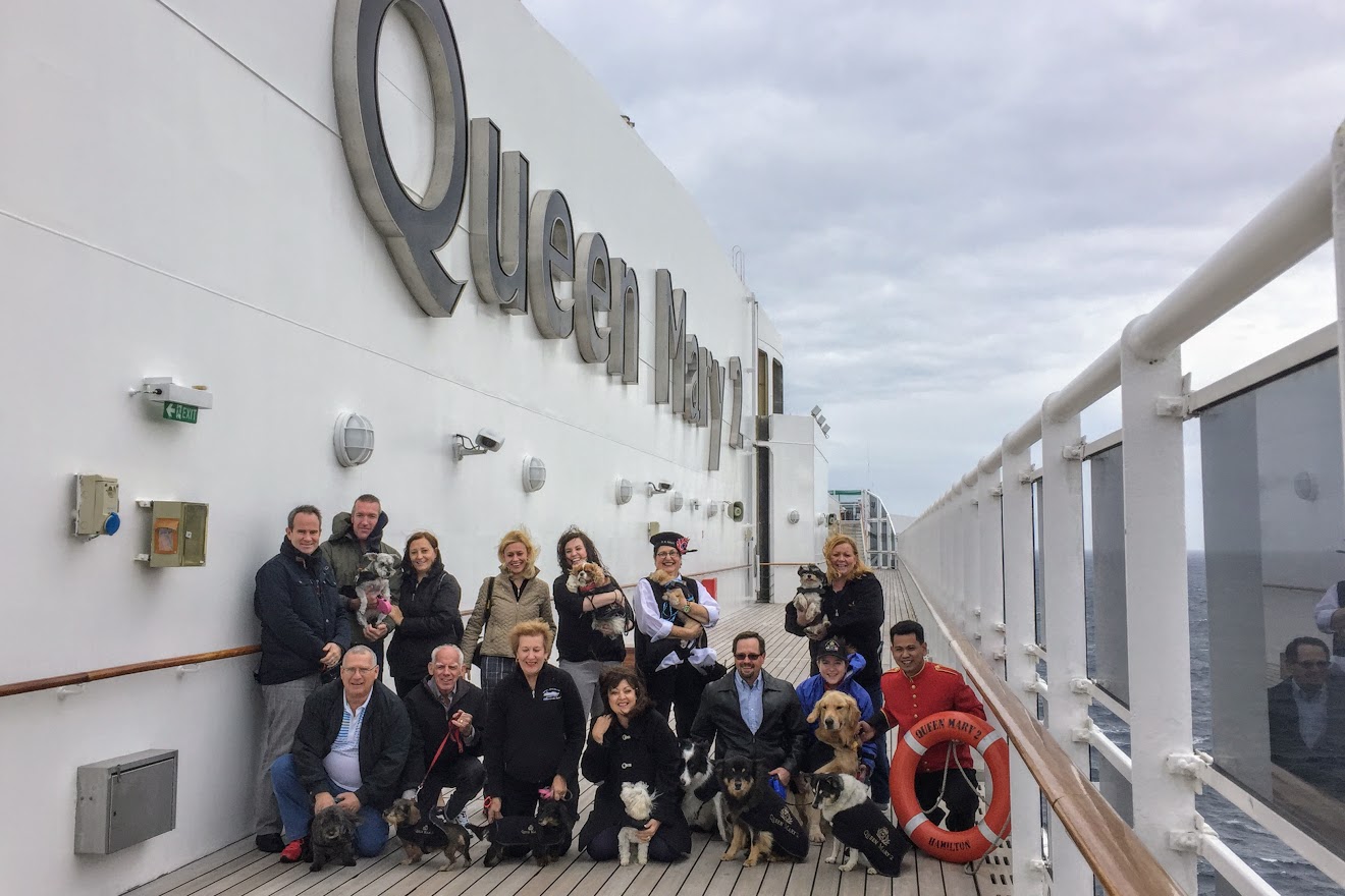 People with dogs in Queen Mary 2 Kennels pose for photo