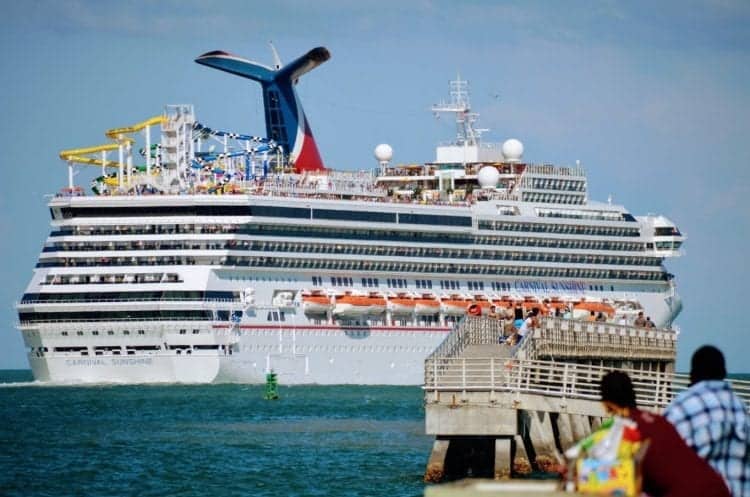 People watch ships sail away from Port Canaveral