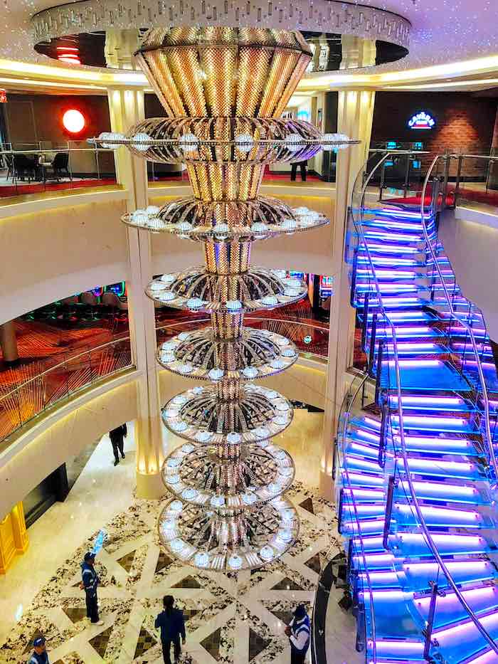 Admire the glittering chandelier and staircase aboard Norwegian Jewel