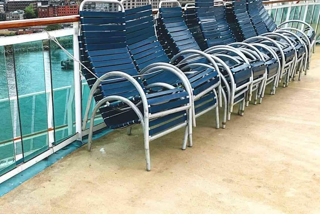 Radiance of the Seas deck chairs tied together at the railing. 