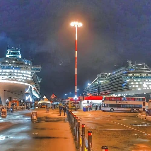 Two cruise ships docked at night in Victoria Canada for required port call.