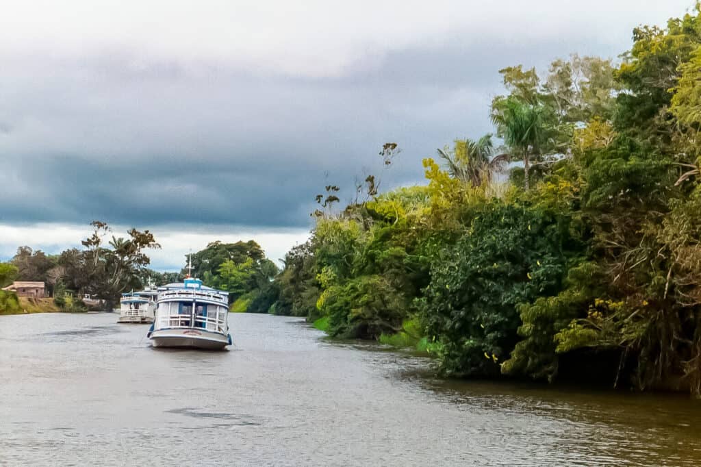 Small boats on Amazon tributary river.