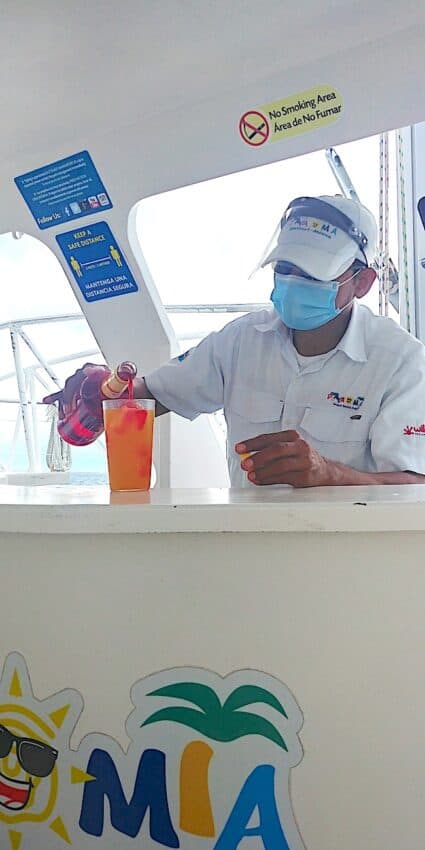 Bartender on our Cozumel Snorkeling Tour pours drinks.