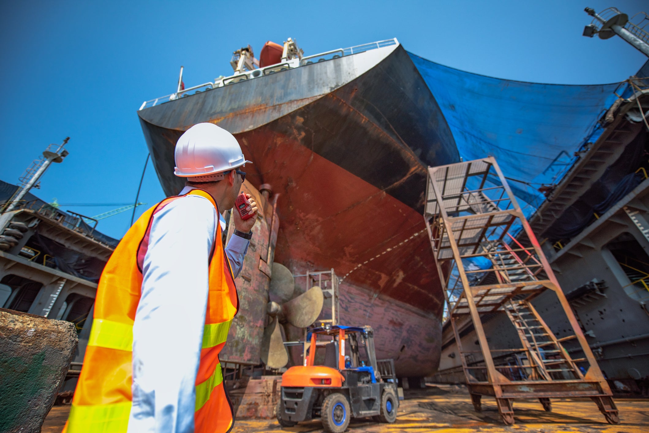 A cruise ship under construction in a shipyard